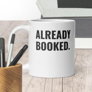“Already Booked.” White glossy mug